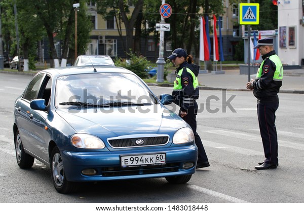 Moscow, Russia - June 28, 2019:\
Russian police patrol inspection checks driver of car on\
street