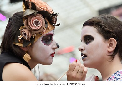 Moscow, Russia - June 29, 2018: The Girl Participant Makes The Sugar Skull Makeup On Face Other Girl During Dia De Los Muertos Mexican Carnival. Day Of The Dead