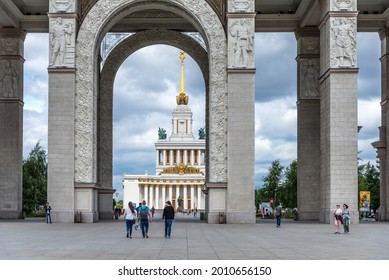 Moscow, Russia - June 30, 2021: Panoramic view of the Main Entrance to VDNKh and walking people in sunny weather in Moscow.