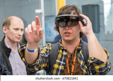 Moscow, Russia - June 8, 2017: Young man testing hololens VR glasses at VR conference
