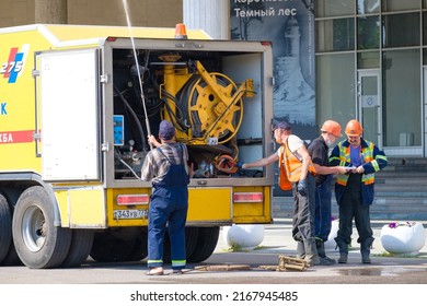 Moscow. Russia. June 9, 2022. A City Utility Worker Sprays Water From A Hose. The Work Of Public Utilities In Moscow On A Sunny Summer Day.