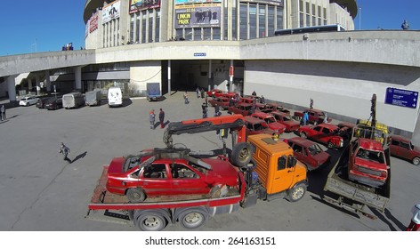 MOSCOW, RUSSIA - MAR 29, 2014: Tow Truck With Crashed Car Is Standing Near Olympiysky Sports Complex At Show Monster Mania. Aerial View