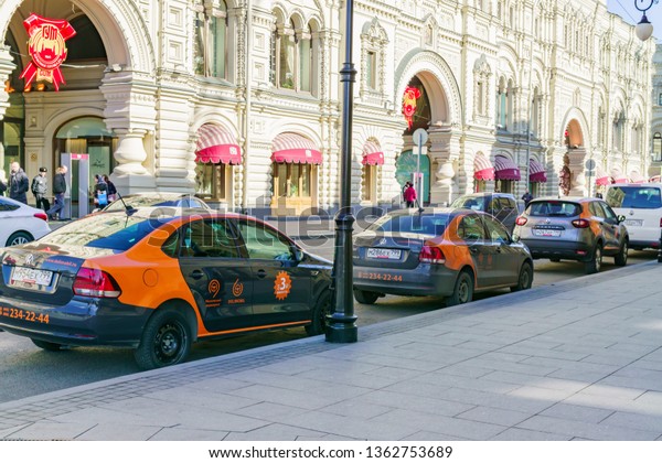 Moscow, Russia - March 03, 2019: Moscow\
carsharing cars (Per-minute car rental) parked along GUM department\
store in city center.