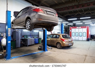 Moscow, Russia - March 19, 2020: Interior Of Auto Repair Workshop, Car On Lift In Mechanic Shop Or Garage, Vehicles Inside Maintenance. Small Service Station During COVID-19 Coronavirus Pandemic.