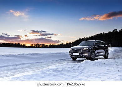 Moscow, Russia - March 19, 2021: Chery Tiggo 8 Pro \ Plus A purple SUV is parked in the forest. Winter snow. drifts, large Chinese premium car.