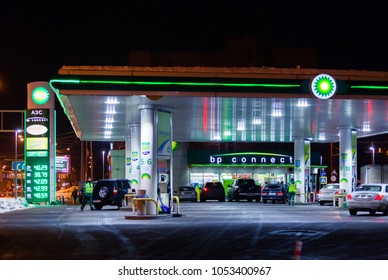 MOSCOW, RUSSIA - MARCH 20, 2018: Cars at the BP Connect gas station on the highway in the busy Moscow district in the evening. The LED display shows the prices of fuel. 