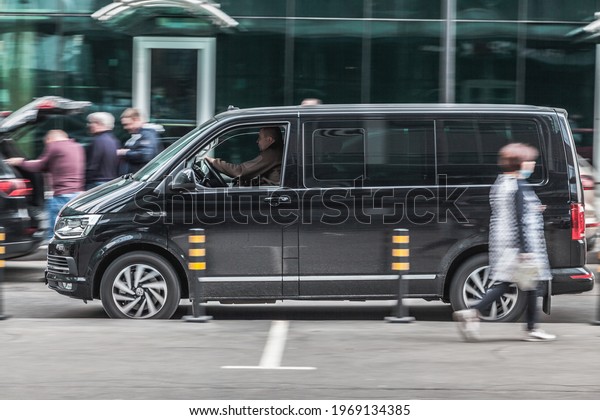 Moscow, Russia - March 2021: Fast moving\
Volkswagen Transporter T6 on the city road. Black van rides on\
street. Commercial auto in fast motion with blurred background.\
speeding in the city\
concept