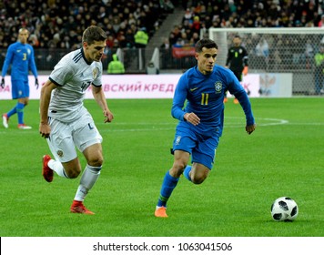 Moscow, Russia - March 23, 2018. Russian midfielder Roman Zobnin and Brazilian attacking midfielder Philippe Coutinho during international test match Russia vs Brazil in Moscow.