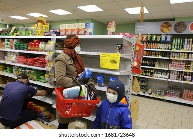 MOSCOW, RUSSIA – MARCH 24, 2020: Covid-19, Coronavirus In Moscow City, Russia. Shopper In Russian Store With Buckwheat, Toilet Paper. Products On Empty Shelves. Medical Mask. Retail, Retailers, Trade