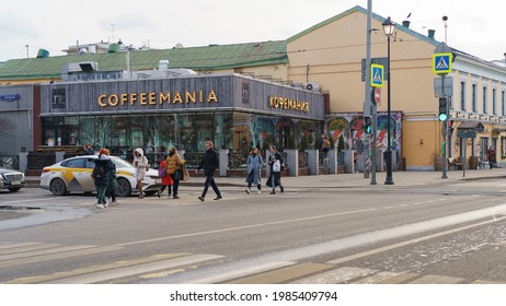 Moscow, Russia - March 26, 2021:People Crossing The Street The Street In Spring Day. Lifestyle Conept. Cafe Exterior. Coffee Mania