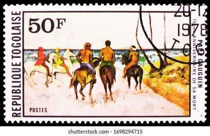 MOSCOW, RUSSIA - MARCH 29, 2020: Postage stamp printed in Togo shows Horsemen on seashore, by Paul Gauguin, Paintings serie, circa 1978