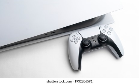 Moscow, Russia - March 8 2021: Presentation of a new product from Sony, wireless white console PlayStation 5 and gamepad on white background, game console
