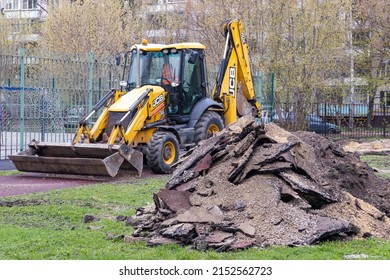 Moscow, Russia - May 04, 2022: Heap and JCB backhoe loader on a city street.