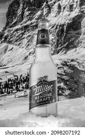 MOSCOW, RUSSIA - MAY 07, 2020: Cooled bottle of Miller Genuine Draft Beer with snow on the background of beautiful mountains. Miller beer is a product of the Miller Brewing Company owned by SABMiller.