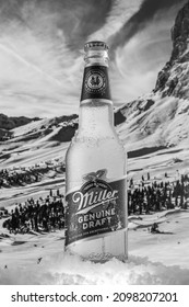 MOSCOW, RUSSIA - MAY 07, 2020: Cooled bottle of Miller Genuine Draft Beer with snow on the background of beautiful mountains. Miller beer is a product of the Miller Brewing Company owned by SABMiller.
