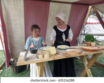 Moscow . Russia. May 1, 2017. Kolomenskoye Park. The St George Tournament. Camp Of Tournament Participants. Young Girl And Her Mum Are Cooking Pasta For A Dinner.                               