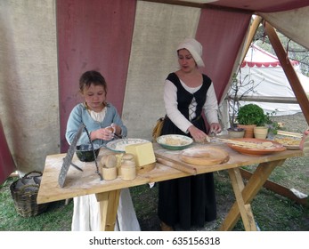 Moscow . Russia. May 1, 2017. Kolomenskoye Park. The St George Tournament. Camp Of Tournament Participants. Young Girl And Her Mum Are Cooking Pasta For A Dinner.                               