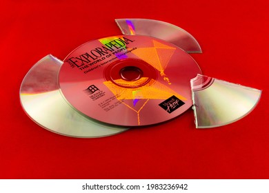 Moscow, Russia - May 11, 2021: A Microsoft Explorapedia encyclopedia CD-ROM, laying near shards of a broken compact disc. CREDIT: Yuri Litvinenko - 30pin