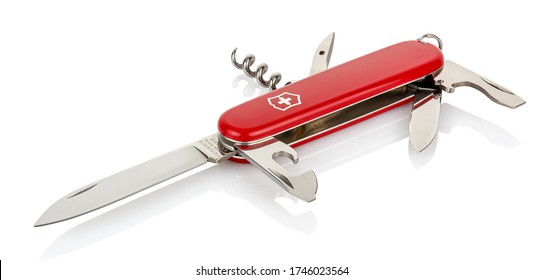 Moscow, Russia - May 15, 2020: Lying Victorinox red classic swiss pocket foldable knife with opened all tools isolated on white background with reflection on glossy surface