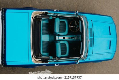 MOSCOW, RUSSIA - MAY 15, 2022: Top view of a 1966 Ford Mustang convertible with an open roof, blue, parked at a retro car exhibition. Blue Ford convertible top view.