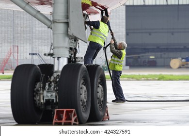 MOSCOW, RUSSIA - MAY 19, 2016: Aircraft  Tu-204 Red Wings airline in the parking lot of the airport Domodedovo. Service engineers carried out work on the preparation of the aircraft for the flight.