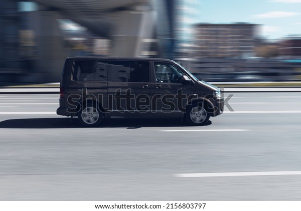Moscow, Russia - May 2022: Fast moving Volkswagen\
Multivan T5 on the city road. Brown van is riding on street.\
Commercial auto in fast motion with blurred background. speeding in\
the city concept