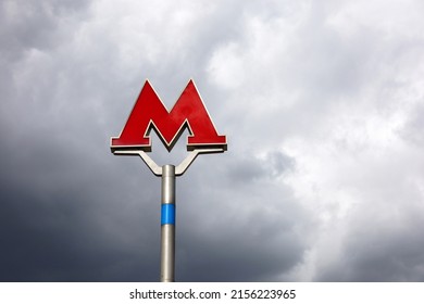 Moscow, Russia - May 2022: Metro Sign For Subway In Moscow Against The Storm Sky