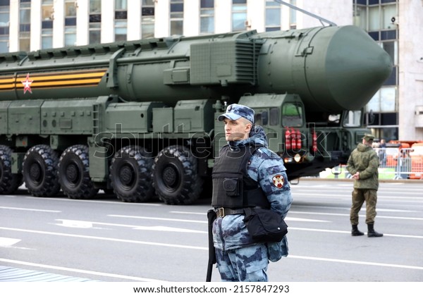 Moscow, Russia - May 2022:\
Nuclear weapon, soldier of russian military forces of National\
Guard standing on background of strategic missile system\
\