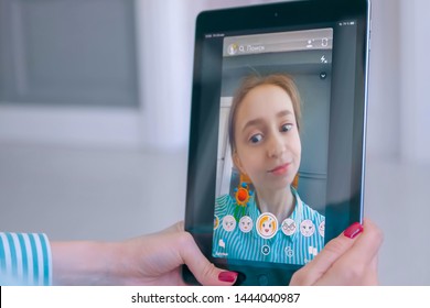 MOSCOW, RUSSIA - MAY 24, 2019: Woman Using Snapchat Multimedia Messaging App With 3d Face Mask Filter On Tablet At Home. Face Detection Technology, AR, Social Media, Selfie, Entertainment Concept