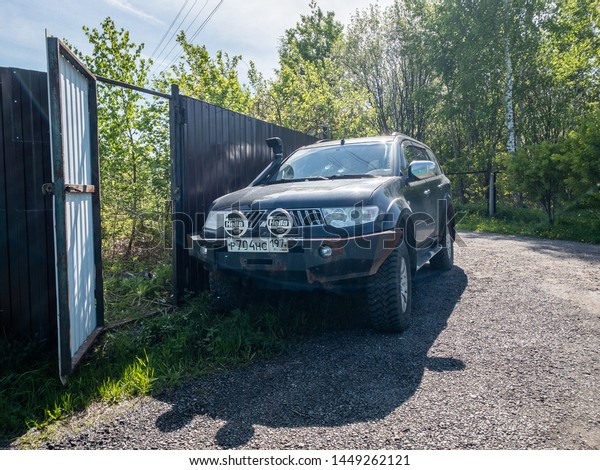 Moscow, Russia - May\
24, 2019: Black Mitsubishi Pajero Sport car parked near the fence\
of a country house