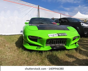 Moscow, Russia - May 25, 2019: Tuned Green Car Mazda RX 7 With Carbon Fiber Hood And A Body Kit. Stands On The Grass.