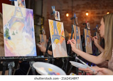 Moscow, Russia - May 26, 2022: Acrylic, Watercolor Or Oil Painting Picture Standing On Black Metal Easel On A Female Artist Or Painter And Colorful Pictures Background At Art Studio.

Drawing Lesson.