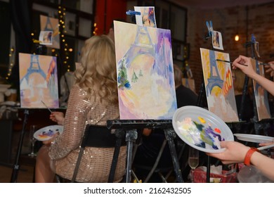 Moscow, Russia - May 26, 2022: Watercolor, Acrylic Or Oil Painting Picture Standing On Black Metal Easel On A Colorful Pictures, Artists (painters) And Hands With Palettes Background.

Drawing Lesson.