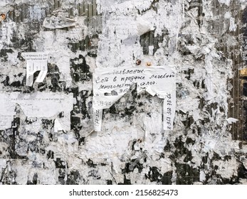 Moscow. Russia. May 6, 2022. Crumpled Worn Advertising Paper Sheet With A Message On A Bulletin Board With Stickers. Abstract Creative Surface.