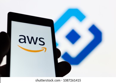 MOSCOW, RUSSIA - MAY 9, 2018: Smartphone In Hand With Amazon Web Services (AWS) Logo. Roskomnadzor (RKN) Emblem On Background. Millions Of IP Was Blocked To Ban Telegram App Messenger. Censorship. VPN