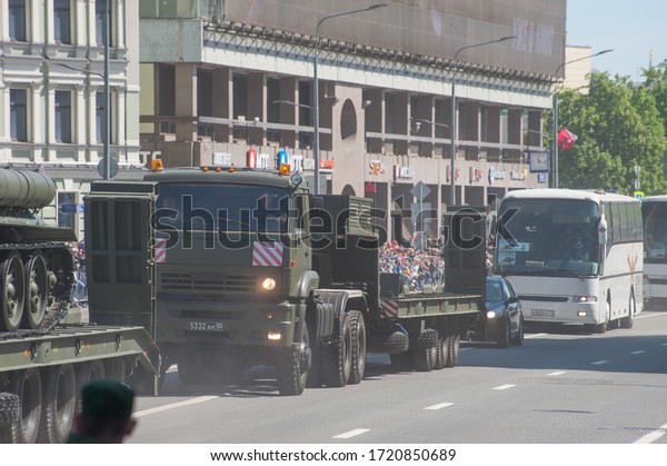 MOSCOW, RUSSIA - May 9, 2018: Russian column of\
auxiliary equipment from KAMAZ-65225 tractors with a semi-trailer\
and buses rides after the Victory day WWII parade along the New\
Arbat, rear view