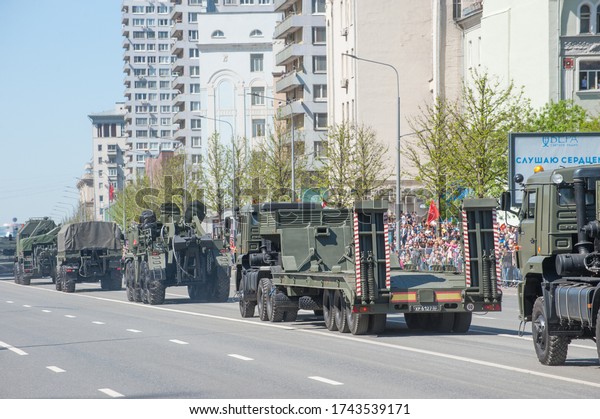 MOSCOW, RUSSIA - May 9, 2018: Russian column of\
auxiliary equipment from MAZ-537 and KAMAZ-65225 tractors with a\
semi-trailer rides after the Victory day WWII parade along the New\
Arbat, rear view