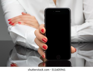 MOSCOW, RUSSIA - NOVEMBER 05, 2016: New Black IPhone 7 Is A Smartphone Developed By Apple Inc. Business Woman Holding Iphone In Hands, Howing To You 