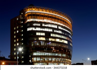 MOSCOW, RUSSIA - NOVEMBER, 06 2015: modern office building with big windows at night, in windows light shines. Moscow, Russia    