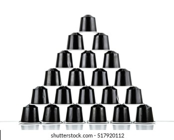 MOSCOW, RUSSIA- NOVEMBER 18, 2016: Black pyramid of Nespresso coffee capsules on white background. Nespresso is worldwide company of coffe pruducts.