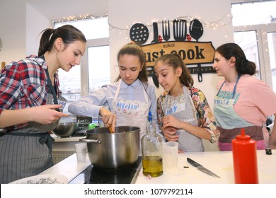 Moscow, Russia, November 21, 2017: Unidentified teenager kids cooking pasta on culinary master class - happy event, devoted to the end of school semester in Moscow.