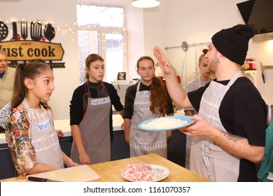 Moscow, Russia, November 21, 2017: Unidentified teenager kids cooking pasta on culinary master class - happy event, devoted to the end of school semester in Moscow.