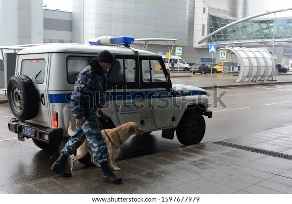  MOSCOW, RUSSIA - NOVEMBER 24, 2015:A
police inspector-dog handler patrols with a dog the territory of
Sheremetyevo international airport in
Moscow