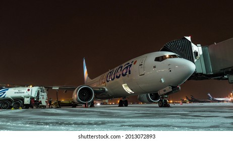 MOSCOW, RUSSIA - NOVEMBER 29, 2017: Timelapse night winter shot of preparing FlyDubai airplane for departure. Boarding with air bridge and loading luggage. Sheremetyevo Airport
