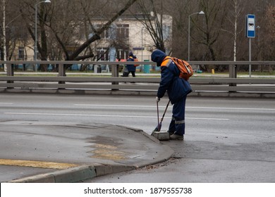 Moscow, Russia, November 30, 2020: Utility Worker In Uniform Sweeps The Sidewalk