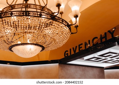 MOSCOW, RUSSIA - November 30 
 2021: Givenchy Luxury Store. French Fashion And Perfume House, Hosting The Brand Of Haute Couture Clothing, Accessories, Cosmetic. Golden Light Of Royal Crystal Chandeli