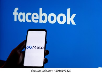 Moscow, Russia - Oct 30 2021: Social media platform will change to Meta to emphasize its metaverse vision.. Smartphone with Meta logo on background of Facebook logo. Renaming and rebranding