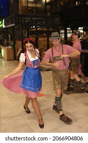 MOSCOW, RUSSIA – OCTOBER 16, 2021: Traditional national Bavarian dances. Oktoberfest festival in Privoz Foodmall Moscow city, Russia. "Bavarian Carousel" band. Folk music, dance. German dancer. Yodel