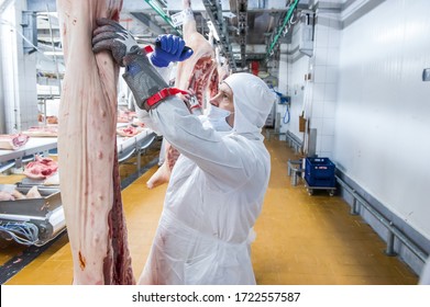 Moscow, Russia. October 17, 2017. Meat Processing Plant. A Worker Is Cutting Pork Carcass.