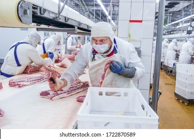 Moscow, Russia. October 17, 2017. Meat Processing Plant. Worker With A Knife Butchering Pork Meat.